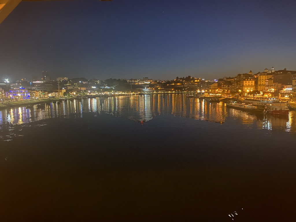 Boats on the Douro river, Vila Nova de Gaia and Porto, viewed from the lower level of the Ponte Luís I bridge, by night