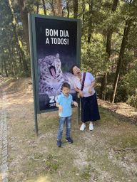 Miaomiao and Max with a sign with a photo of a Jaguar at the entrance road to the Zoo Santo Inácio