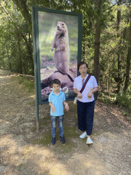 Miaomiao and Max with a sign with a photo of a Prairie Dog at the entrance road to the Zoo Santo Inácio