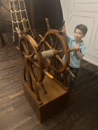 Max with a steering wheel at the Porto Region Across the Ages museum at the WOW Cultural District