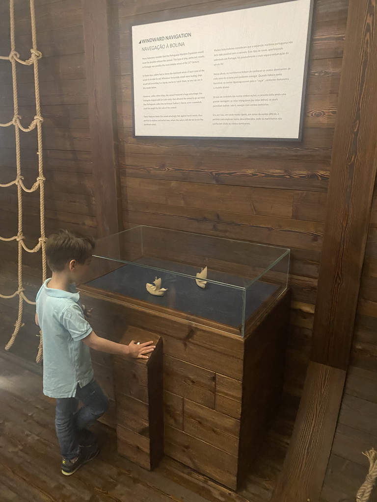 Max with scale models of boats and information on Windward Navigation at the Porto Region Across the Ages museum at the WOW Cultural District