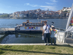 Miaomiao and Max in front of the ferry over the Douro river at the ferry dock at the Avenida de Diogo Leite street and Porto with the Cais da Estiva and Cais da Ribeira streets, the Igreja de Nossa Senhora da Vitória church, the Torre dos Clérigos tower and the Igreja dos Grilos church