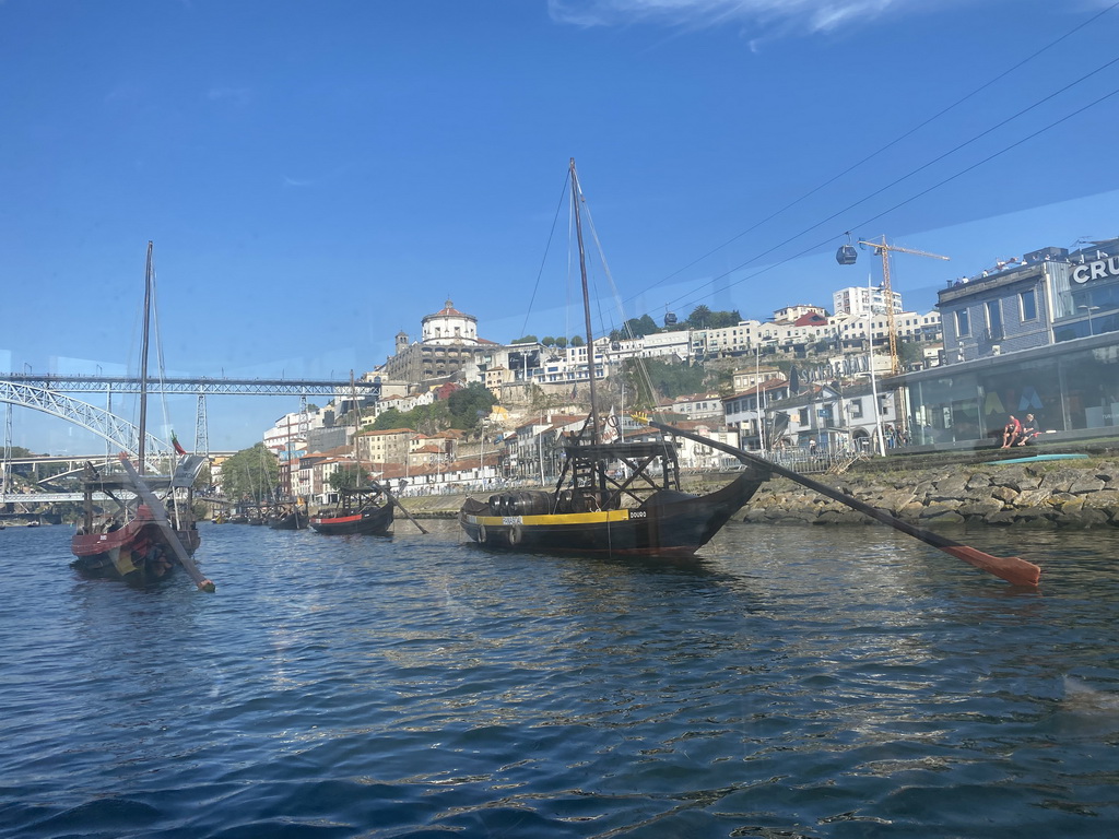 Boats and the Ponte Luís I bridge over the Douro river and the Mosteiro da Serra do Pilar monastery, viewed from the ferry over the Douro river