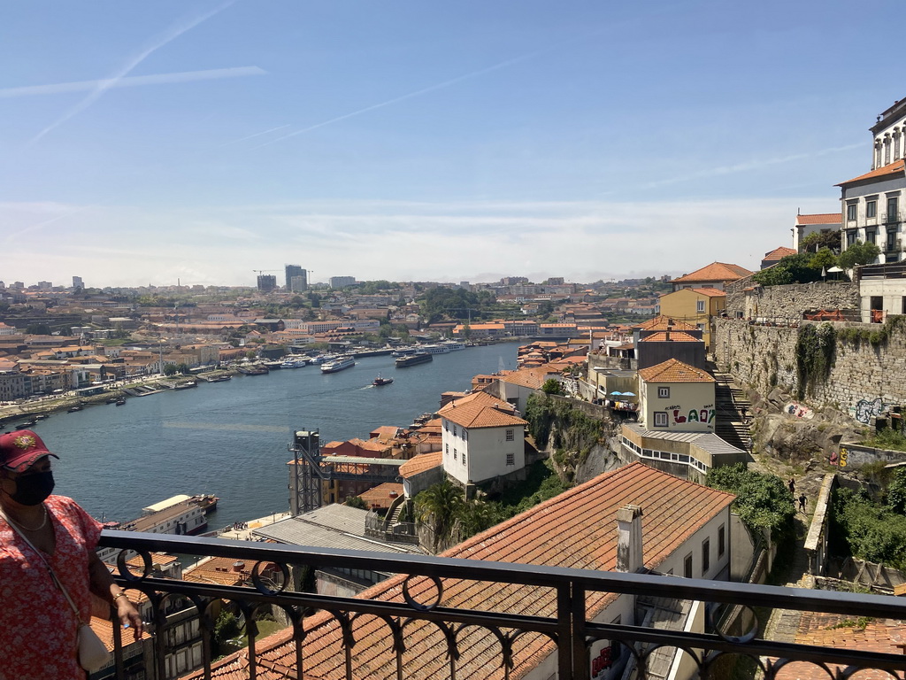 Boats over the Douro river, the Avenida de Diogo Leite street and Porto with the Elevador da Ribeira lift, viewed from the subway train on the Ponte Luís I bridge