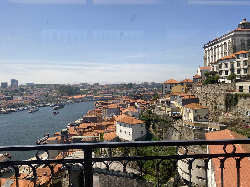 Boats over the Douro river, the Avenida de Diogo Leite street and Porto with the Elevador da Ribeira lift and the Paço Episcopal do Porto palace, viewed from the subway train on the Ponte Luís I bridge