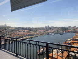 Boats over the Douro river, the Avenida de Diogo Leite street and Porto with the Cais da Ribeira street, viewed from the subway train on the Ponte Luís I bridge