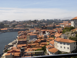 Boats over the Douro river and Porto with the Cais da Ribeira street, the Igreja Monumento de São Francisco church and the Palácio da Bolsa palace, viewed from the subway train on the Ponte Luís I bridge