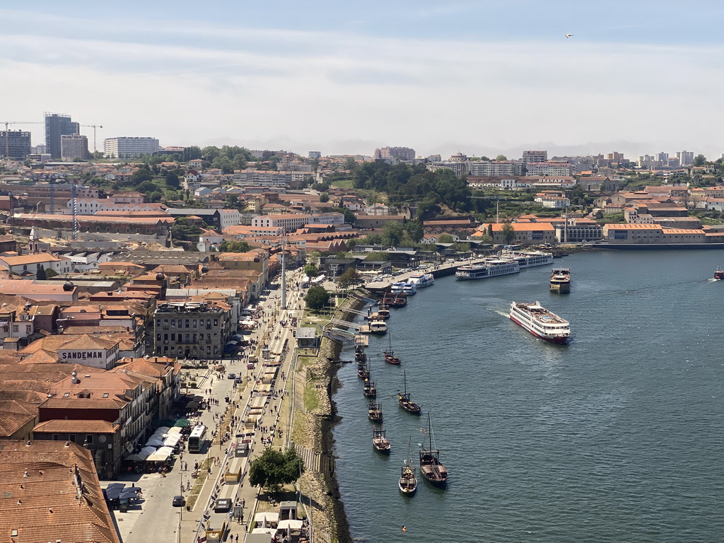 Boats over the Douro river, the Avenida de Diogo Leite street, the Igreja Paroquial de Santa Marinha church and the Gaia Cable Car, viewed from the subway train on the Ponte Luís I bridge