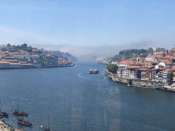 Boats and the Ponte da Arrábida bridge over the Douro river and Porto with the Cais da Estiva street, viewed from the Gaia Cable Car