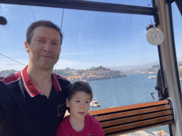 Tim and Max at the Gaia Cable Car, with a view on boats and the Ponte da Arrábida bridge over the Douro river
