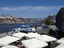 Boats and the Ponte Luís I bridge over the Douro river, the Cais de Gaia street, the Mosteiro da Serra do Pilar monastery and Porto with the Cais da Ribeira street, the Porto Cathedral and the Paço Episcopal do Porto palace, viewed from the Sancho Panza restaurant