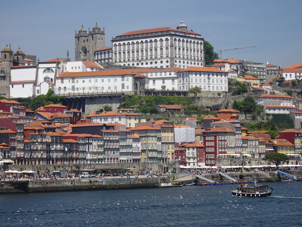 Boats on the Douro river and Porto with the Cais da Ribeira street, the Igreja dos Grilos church, the Porto Cathedral and the Paço Episcopal do Porto palace, viewed from the Sancho Panza restaurant