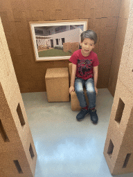 Max on a cork seat in a cork house at the Planet Cork museum at the WOW Cultural District