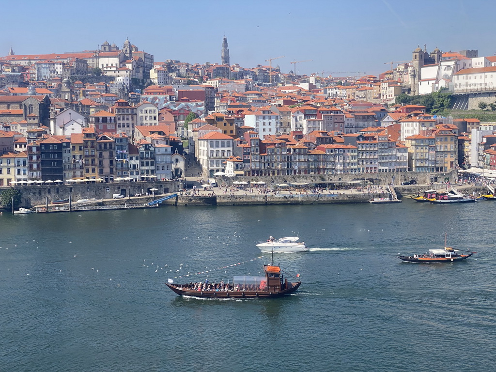 Boats on the Douro river and Porto with the Cais da Estiva and Cais da Ribeira streets, the Capela de Nossa Senhora do Ó chapel, the Mercado Ferreira Borges market, the Igreja de Nossa Senhora da Vitória church, the Torre dos Clérigos tower and the Igreja dos Grilos church, viewed from the Gaia Cable Car