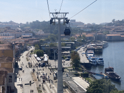 Boats on the Douro river, the Avenida de Diogo Leite street and the Gaia Cable Car building at the Avenida de Ramos Pinto street, viewed from the Gaia Cable Car