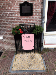 Plaque and sign at the front of the Hotel de Wereld at the 5 Mei Plein square