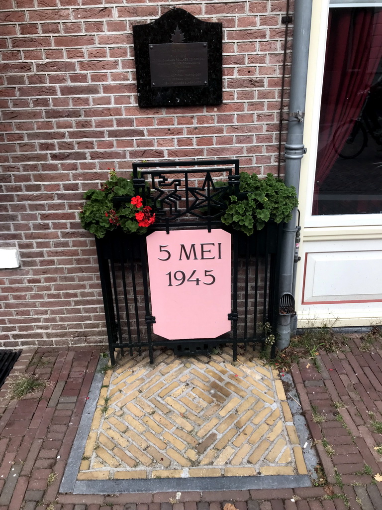 Plaque and sign at the front of the Hotel de Wereld at the 5 Mei Plein square