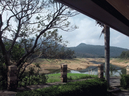 Grassfield, lake, trees and mountains, viewed from the touring car at the Xinglong Tropical Garden