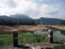 Grassfield, lake, trees and mountains, viewed from the touring car at the Xinglong Tropical Garden