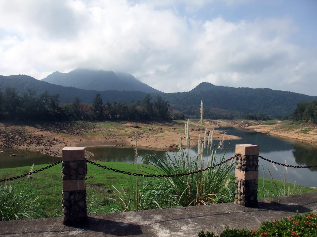 Grassfield, lake, trees and mountains, viewed from the touring car at the Xinglong Tropical Garden