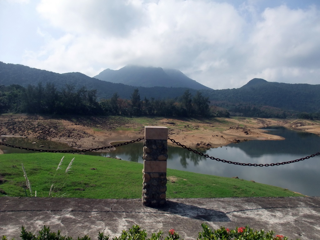 Grassfield, lake, trees and mountains, viewed from the touring car at the Xinglong Tropical Garden