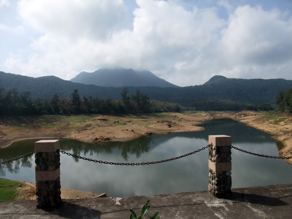 Lake, trees and mountains, viewed from the touring car at the Xinglong Tropical Garden