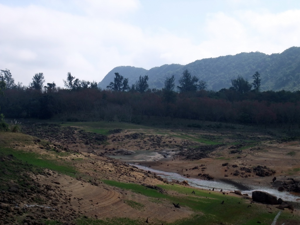 Grassland, river, trees and hills, viewed from the Xinglong Tropical Garden
