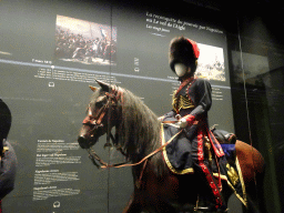 Statue of a French soldier on a horse at the Lower Floor of the Mémorial 1815 museum, with explanation