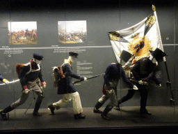 Statues of allied soldiers at the Lower Floor of the Mémorial 1815 museum, with explanation