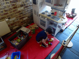Max playing with a toy kitchen at the Le Bivouac de l`Empereur restaurant