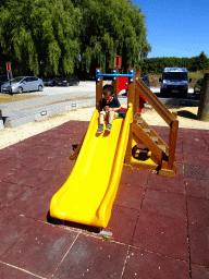 Max on the slide of the playground at the Le Bivouac de l`Empereur restaurant
