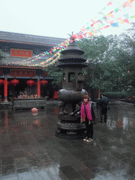 Miaomiao at an incense burner in front of a temple at the Yuchan Palace at the Hainan Wenbifeng Taoism Park