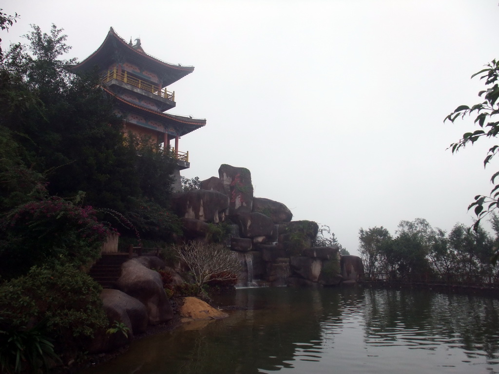 Drum tower and waterfall at the Yuchan Palace at the Hainan Wenbifeng Taoism Park