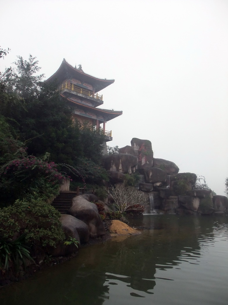 Drum tower and waterfall at the Yuchan Palace at the Hainan Wenbifeng Taoism Park