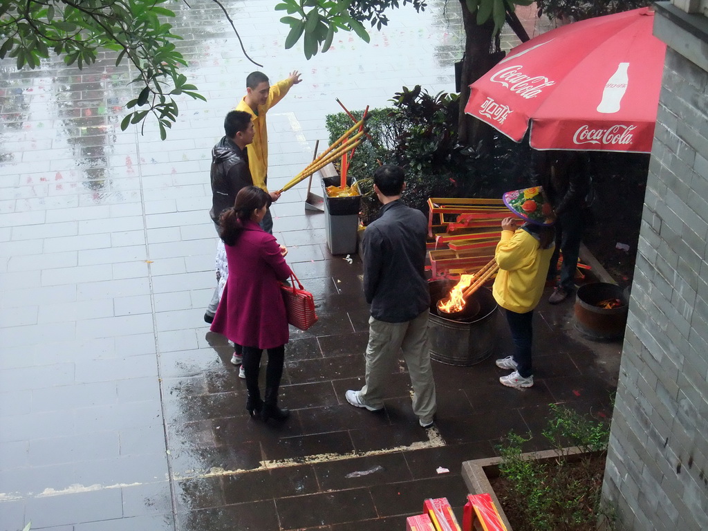 People burning incense at the Yuchan Palace at the Hainan Wenbifeng Taoism Park