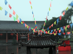 Temple, incense burners and flags at the east side of the Hainan Wenbifeng Taoism Park