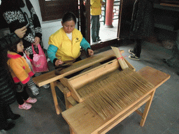 Woman making incense sticks at the Nanjianzhou Ancient City at the Hainan Wenbifeng Taoism Park