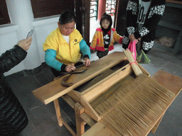 Woman making incense sticks at the Nanjianzhou Ancient City at the Hainan Wenbifeng Taoism Park