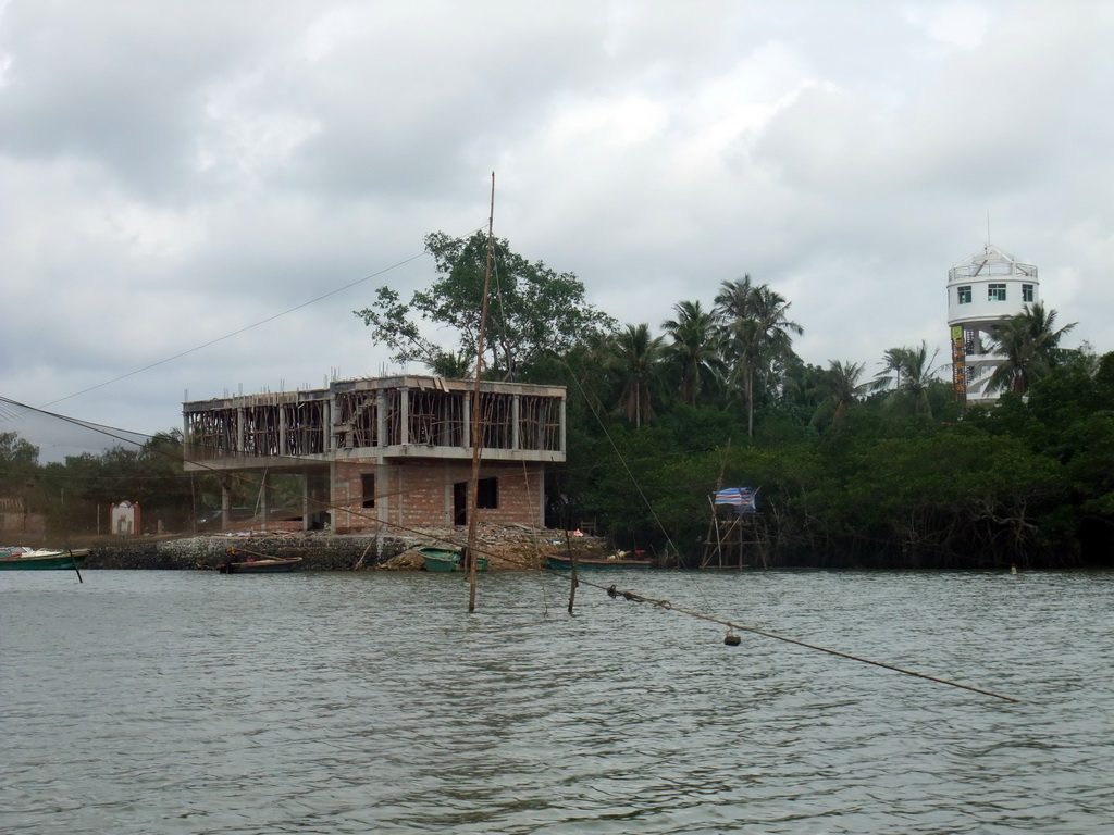 House and tower at the Xiachang Service Area at Bamenwan Bay, viewed from the tour boat