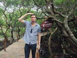 Tim with warning sign at the Bamenwan Mangrove Forest
