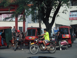 Motorcycles and rickshaws in the town of Wenchang