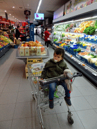 Max on a shopping cart in a supermarket in Barvaux-sur-Ourthe