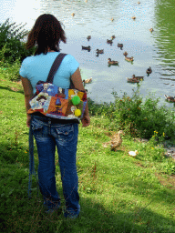 Miaomiao with ducks at a canal at the town center
