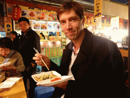 Tim eating an oister omelet at a snack stall at the Taiwan Snack Street at Renhe Road