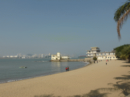 Buildings at the beach at the west side of Gulangyu Island, Xiamen Bay and skyscrapers at the Haicang district