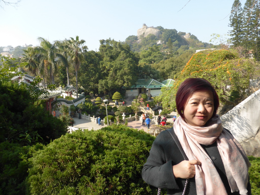 Miaomiao at the path to the Piano Museum at Gulangyu Island, with a view on the Shan Pavilion, the Twelve Grotto Heaven and Sunshine Rock