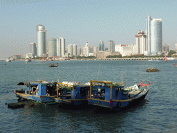 Boats in Xiamen Bay and skyscrapers at the west side of Xiamen Island, viewed from Yanping Road at Gulangyu Island