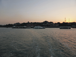 Boats in Xiamen Bay and the San Qiu Tian Ferry Terminal, the dome of the Gulangyu Organ Museum and Sunlight Rock at Gulangyu Island, viewed from the ferry to Xiamen Island