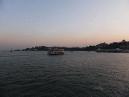 Boats in Xiamen Bay and the San Qiu Tian Ferry Terminal, the dome of the Gulangyu Organ Museum and Sunlight Rock at Gulangyu Island, viewed from the ferry to Xiamen Island
