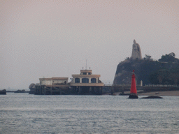 The large statue of Zheng Chenggong on Fuding Rock at the Haoyue Park and a pier with pavilion at Gulangyu Island, viewed from the ferry to Xiamen Island